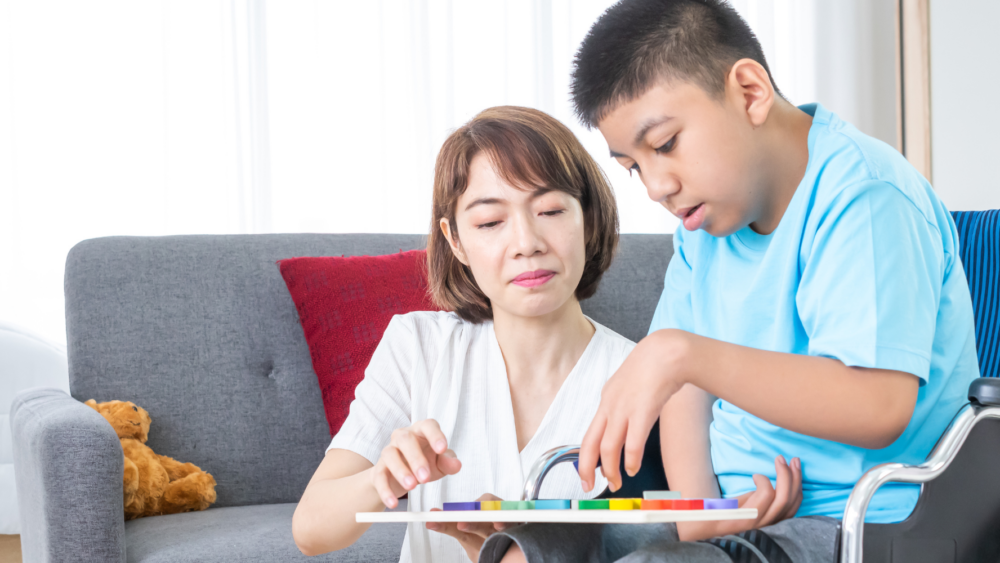 Child with Special Needs Assisted by an Adult