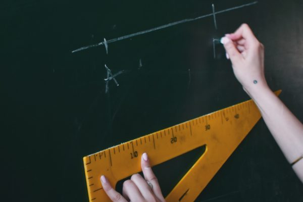 Student Writing on Chalkboard