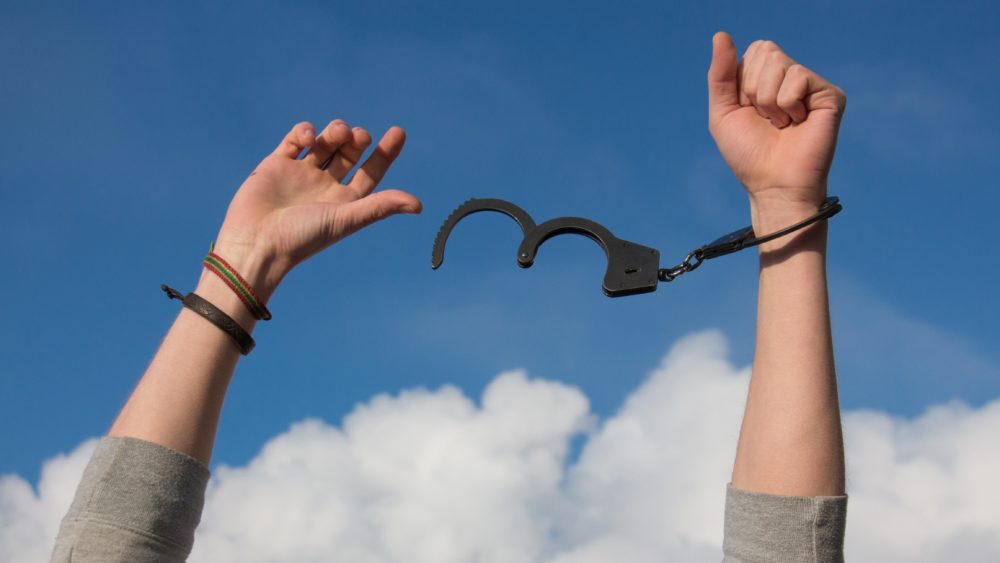 Child Pulling Off Handcuffs With Hands in Air