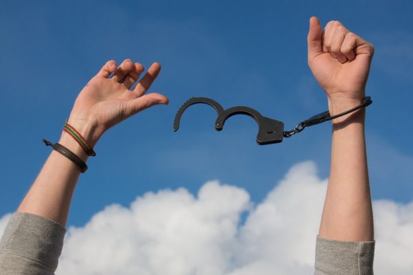 Child Pulling Off Handcuffs With Hands in Air