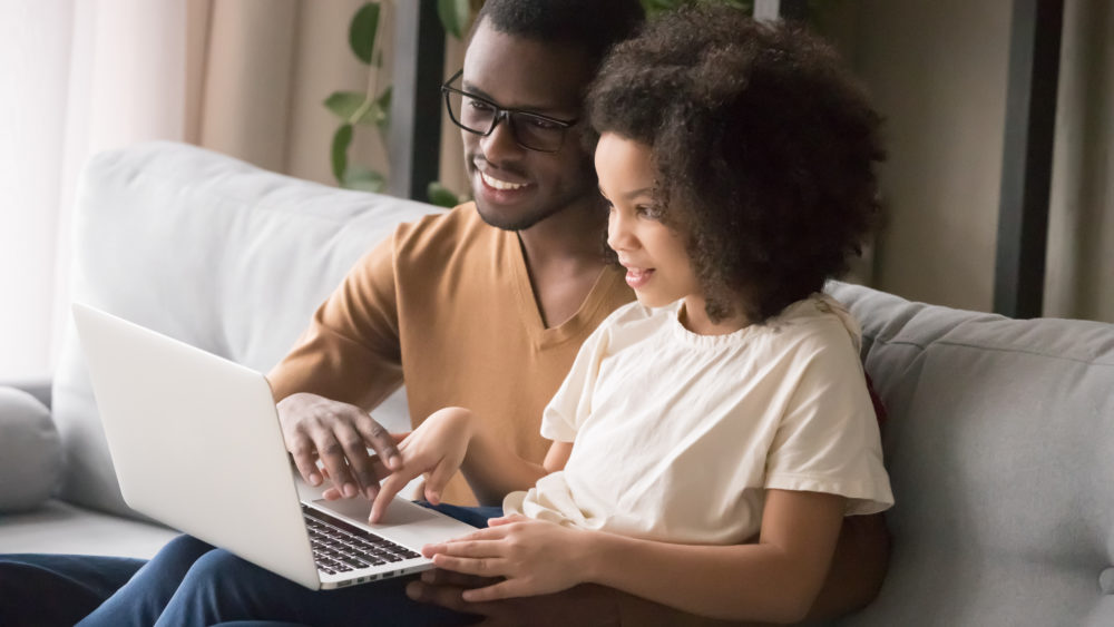 Father helping daughter with schoolwork