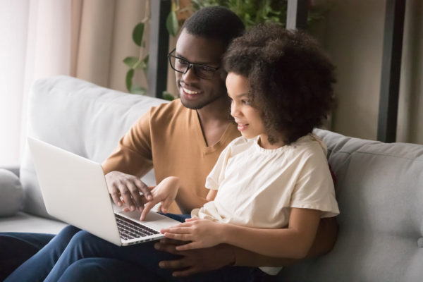 Father helping daughter with schoolwork